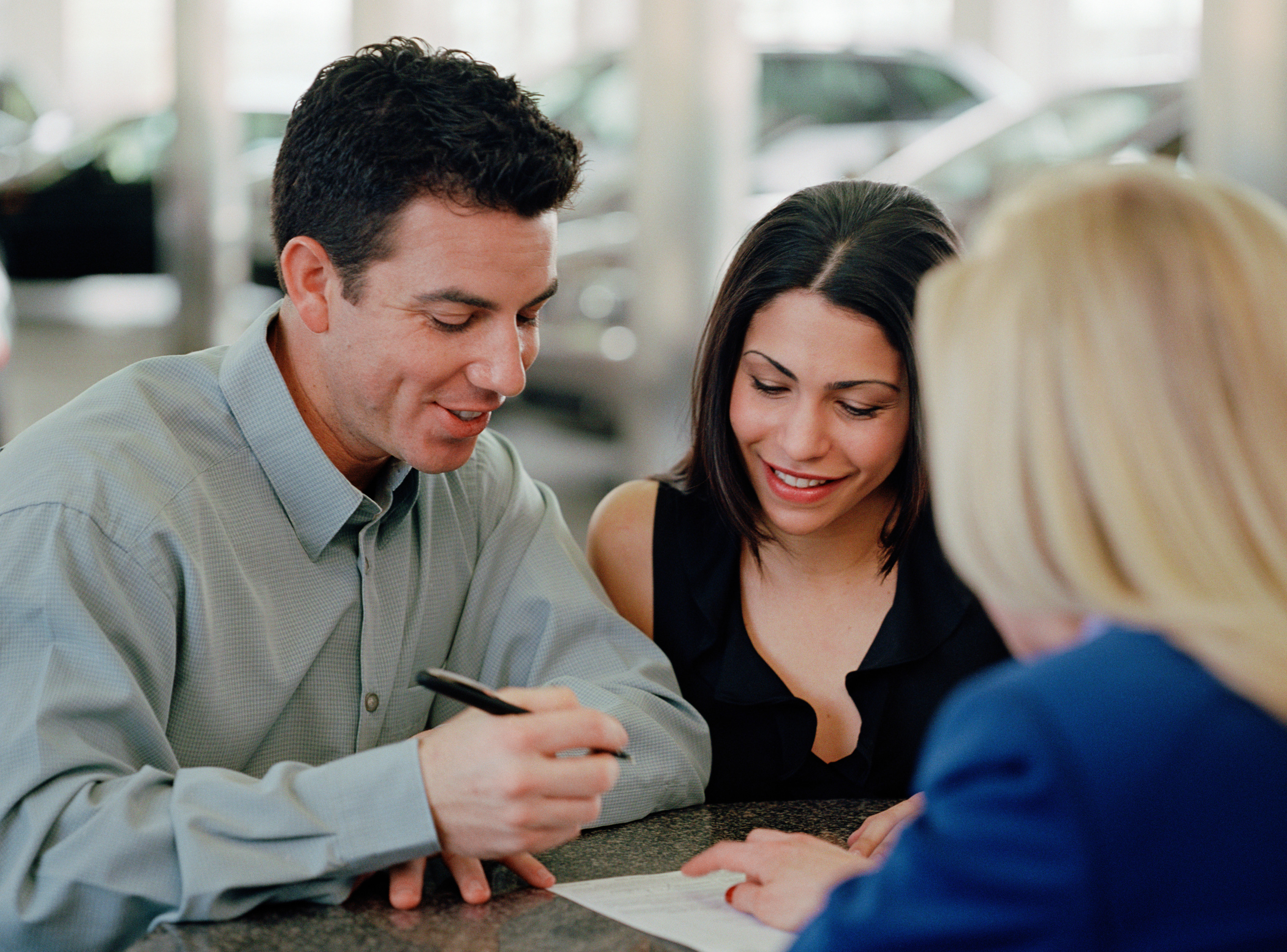 Couple signing paperwork